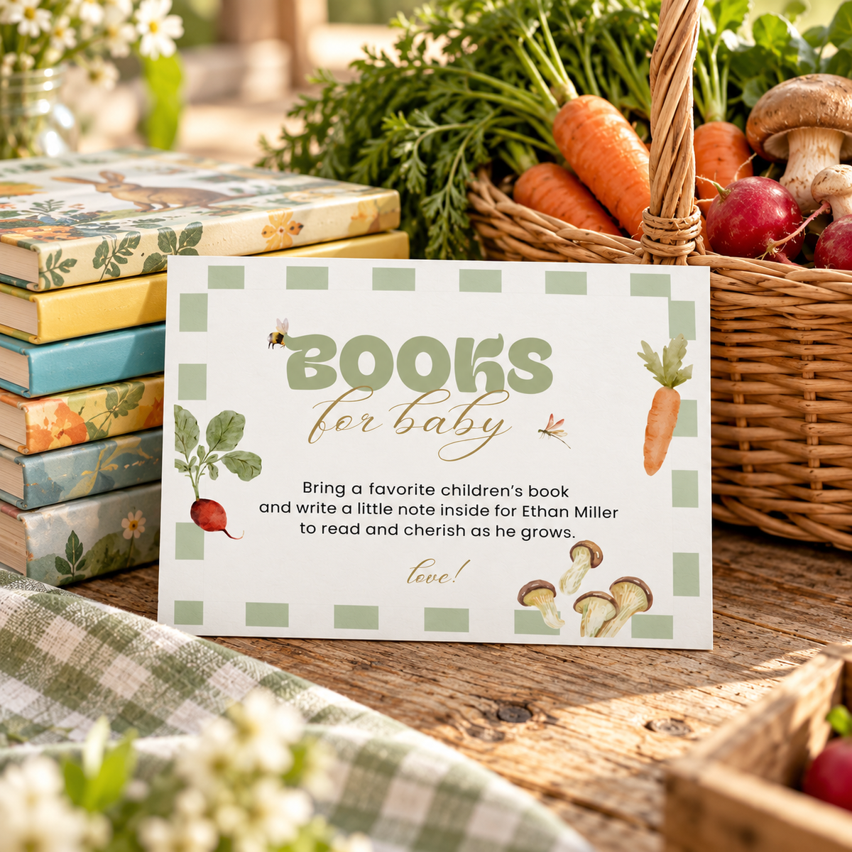 Books for baby card leaning on a stack of children's books next to a basket of vegetables