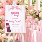 Ready To Pop welcome sign on an easel beside a pink baby shower gift table with balloons