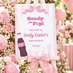 Close-up of the Ready To Pop pink striped welcome sign with pink roses and a satin bow
