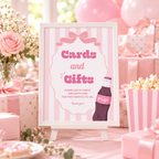 Ready To Pop Cards and Gifts sign on an easel at a pink baby shower gift table