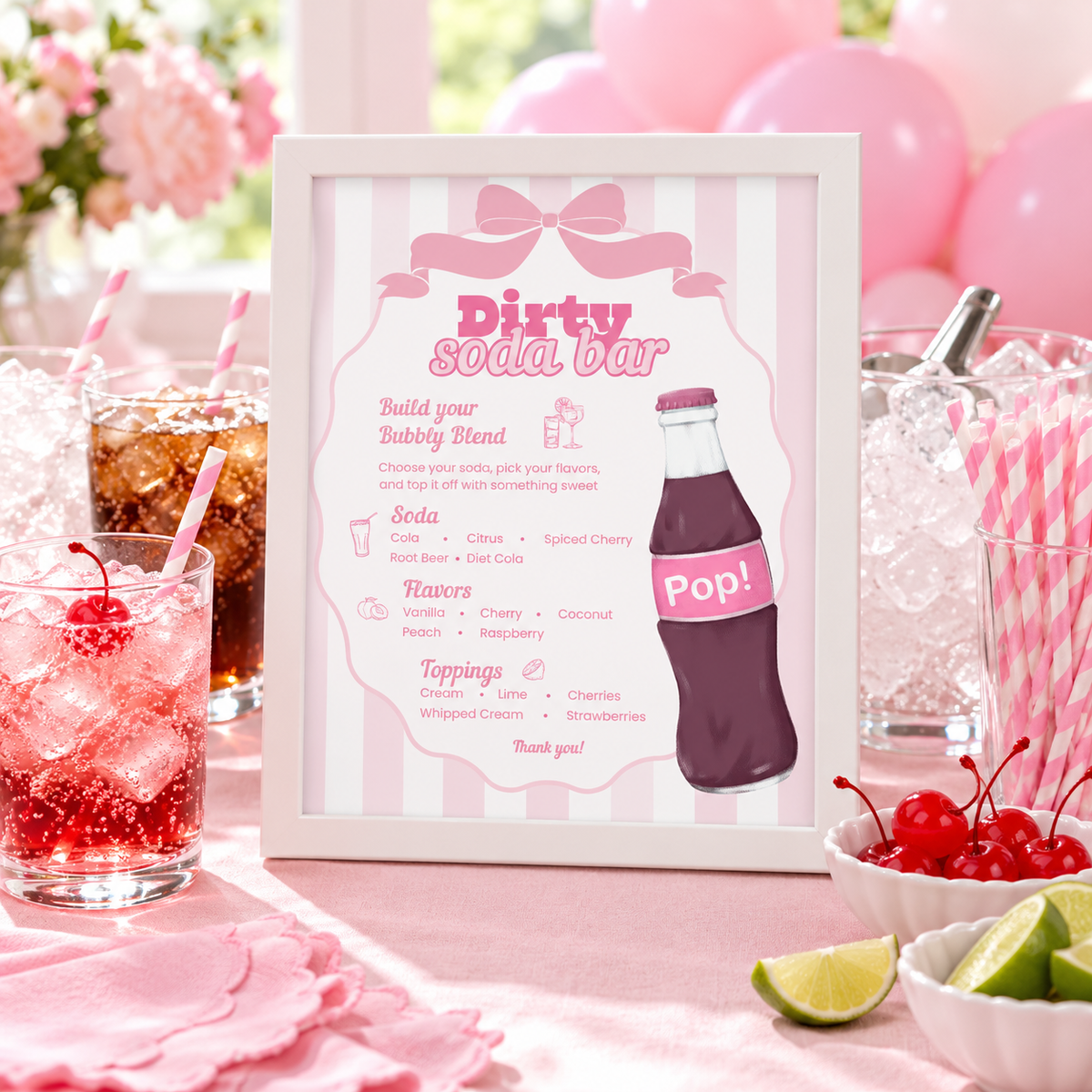 Ready To Pop Dirty Soda Bar sign in a white frame on a pink baby shower drink station with soda glasses and striped straws