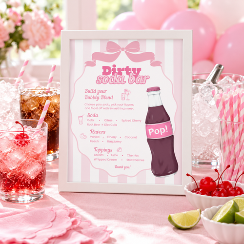 Ready To Pop Dirty Soda Bar sign in a white frame on a pink baby shower drink station with soda glasses and striped straws