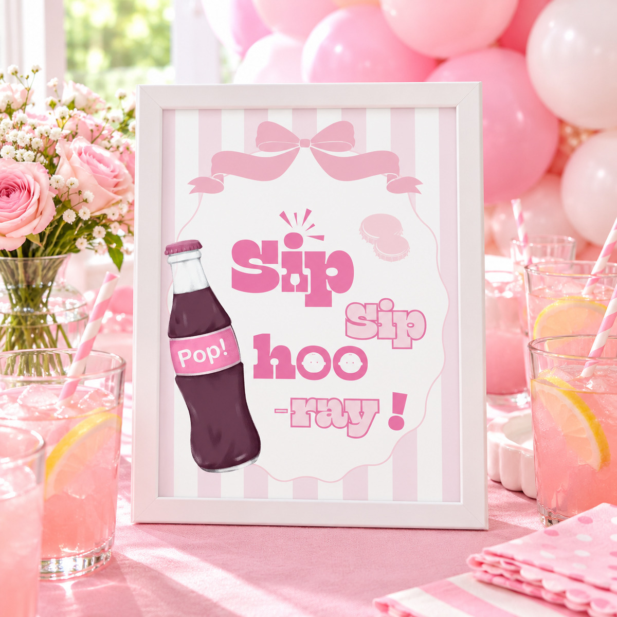 Ready To Pop Sip Sip Hooray sign framed on a pink drinks table with balloons and pink lemonade
