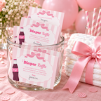 Filled-in Ready To Pop diaper raffle cards in a glass jar next to a stack of diapers tied with a pink bow