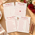 Special Delivery baby shower game cards fanned on a table with pencils and red and cream flowers