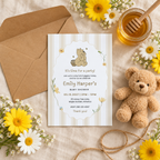 Classic Honey Bear baby shower invitation flat lay with kraft envelope, twine, teddy bear and daisies