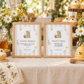 Classic Honey Bear Drinks Station and Favors Table signs in wood frames on a baby shower buffet with honey jars and daisies