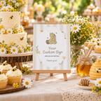 Classic Honey Bear custom party sign on a small easel on a baby shower dessert table with cake and honey jars