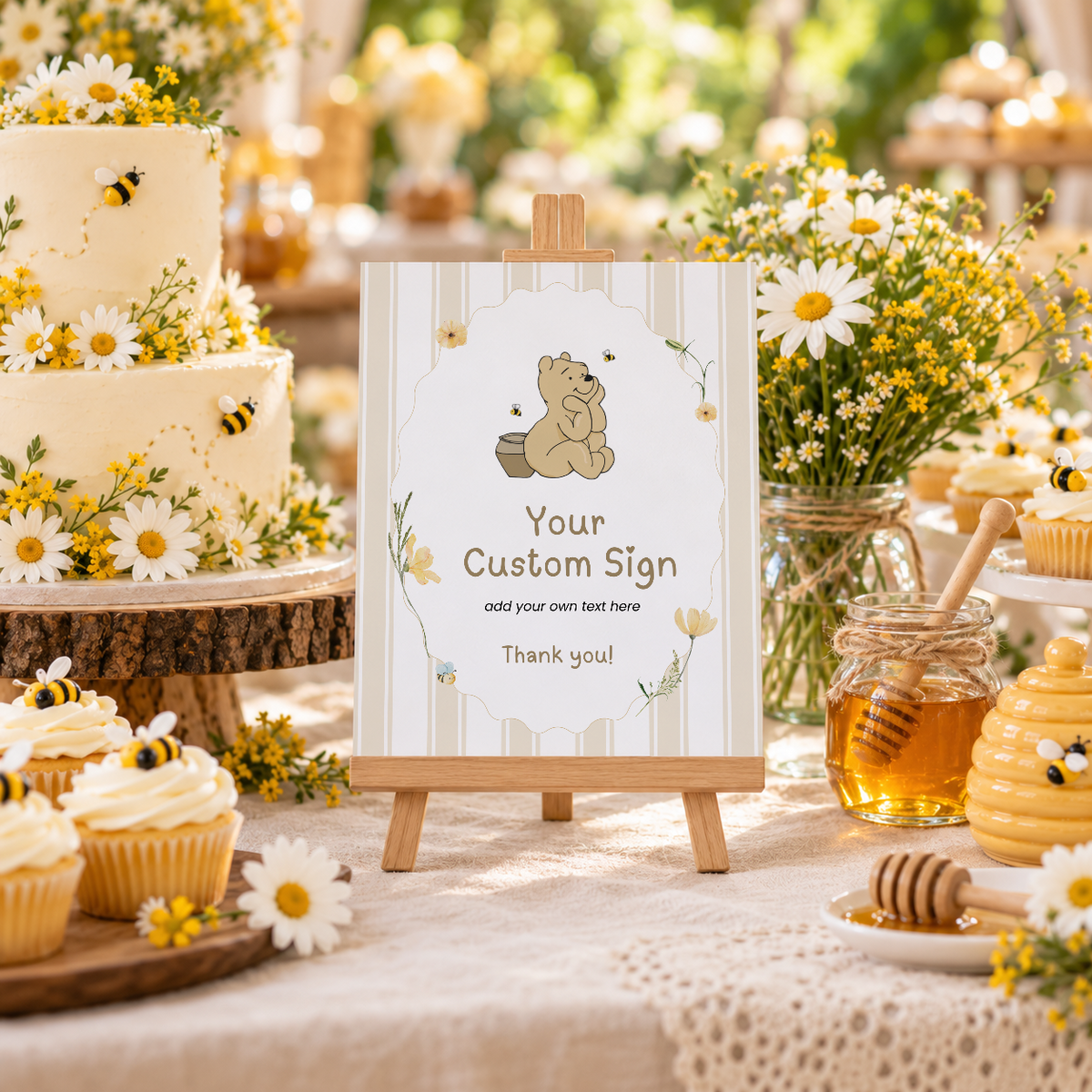 Classic Honey Bear custom party sign on a small easel on a baby shower dessert table with cake and honey jars