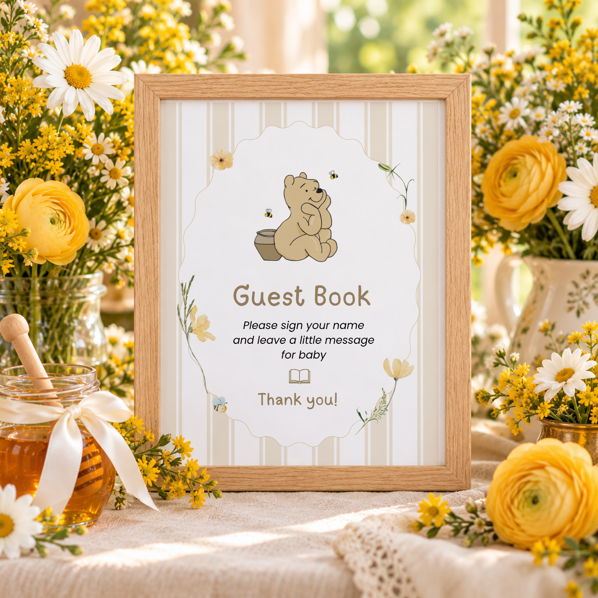 Close-up of the framed Classic Honey Bear Guest Book sign with yellow flowers and a honey jar