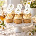 Classic Honey Bear baby shower cupcake toppers on cupcakes on a white cake stand with daisies and a honey jar