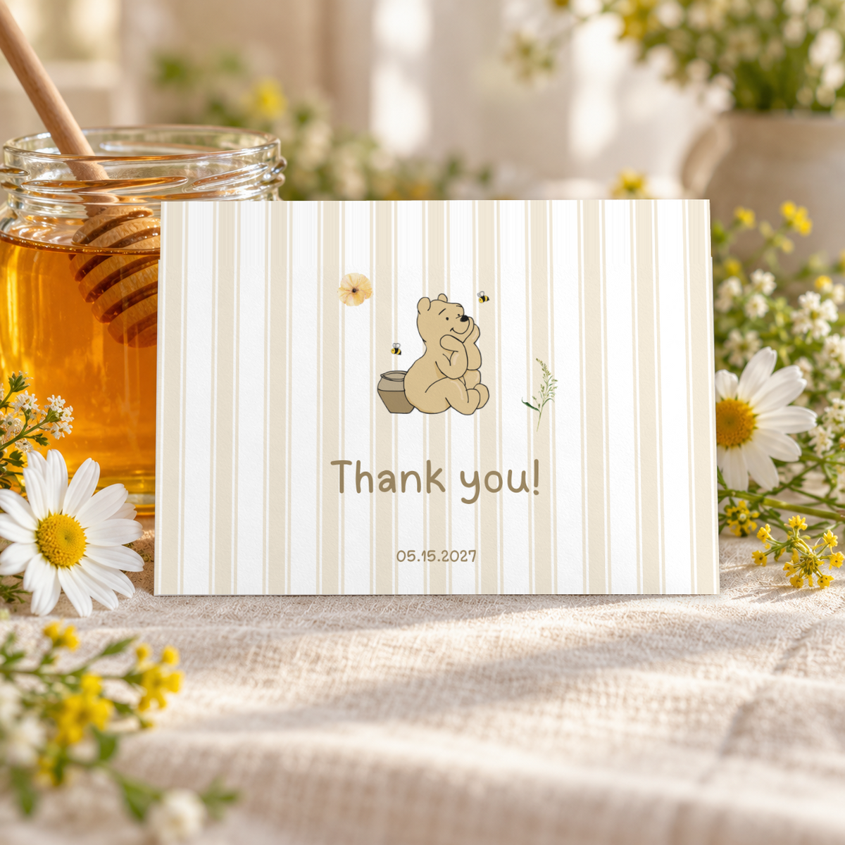 Classic Honey Bear thank you card propped against a honey jar with a honey dipper and daisies