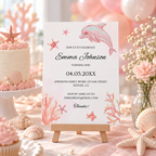 Ocean themed first birthday party table with the printed under the sea invitation on an easel, cake and pink balloons